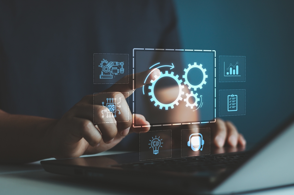 A person interacting with a virtual interface displaying automation icons and gear symbols, representing AI integration and digital transformation.